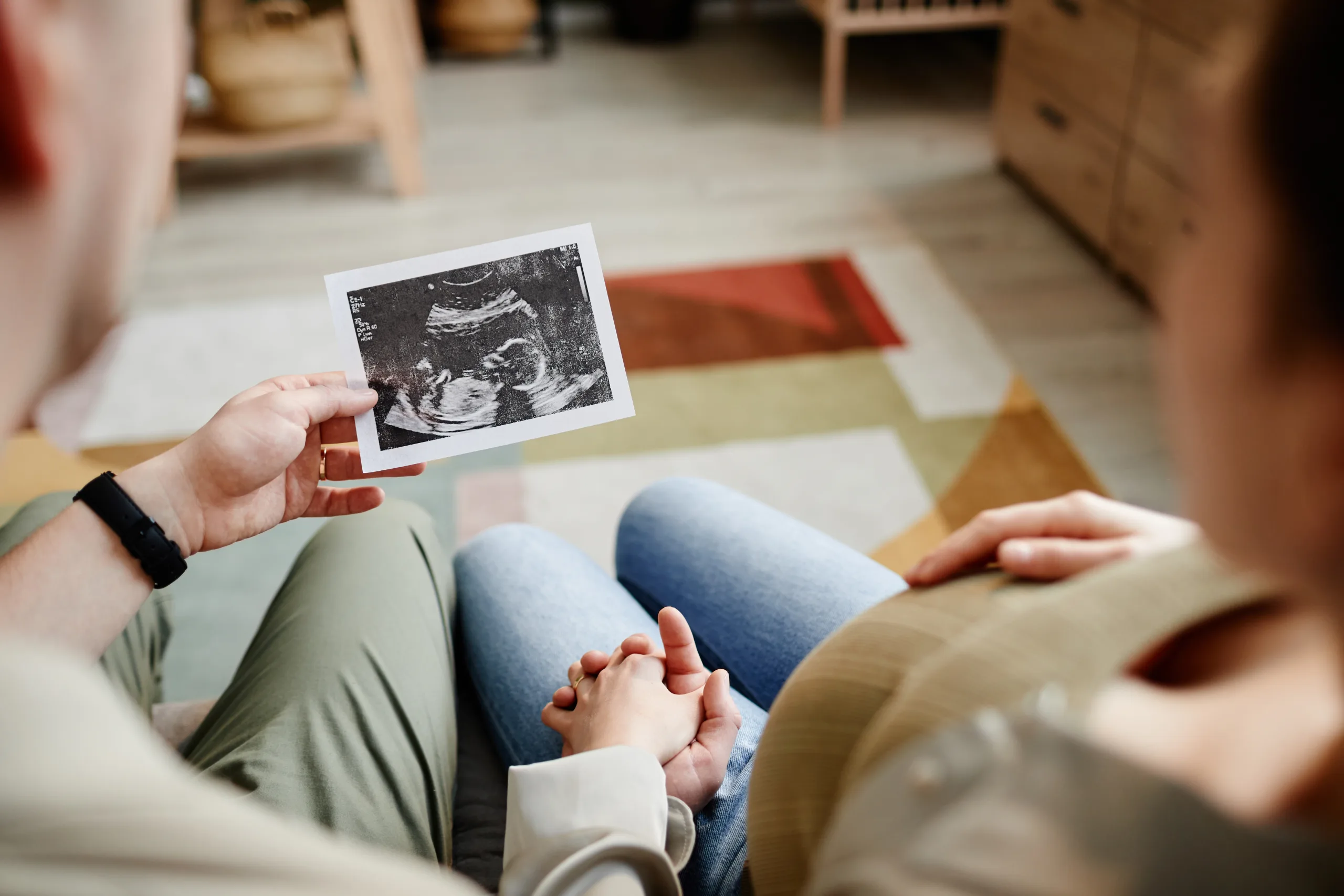 A couple sitting together looking at an ultrasound picture