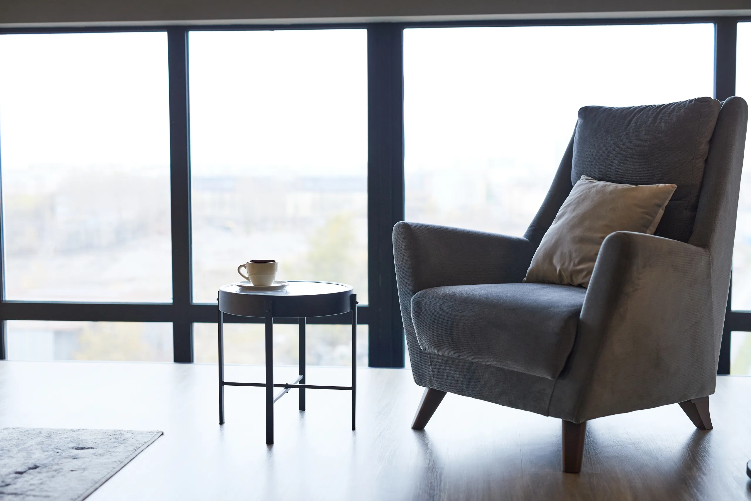 An armchair beside a window in soft daylight